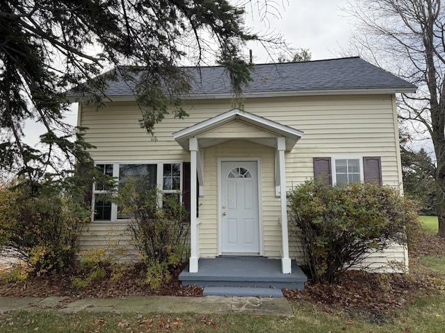 view of front of property featuring a shingled roof