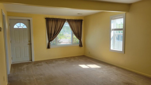 entrance foyer with visible vents, baseboards, and carpet floors