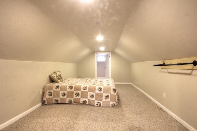 unfurnished bedroom featuring carpet flooring, baseboards, and lofted ceiling