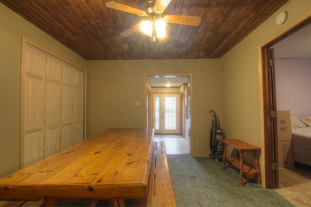 carpeted dining area featuring a ceiling fan and wood ceiling