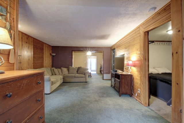 living room featuring light carpet and wood walls