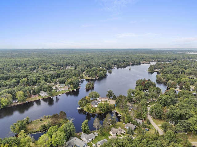 aerial view with a wooded view and a water view