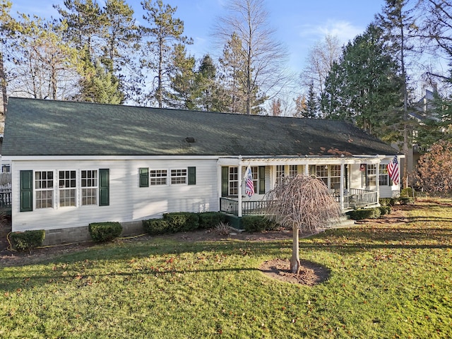 view of front of house with crawl space, a front lawn, and roof with shingles