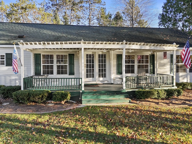 view of front facade with covered porch, a pergola, and roof with shingles