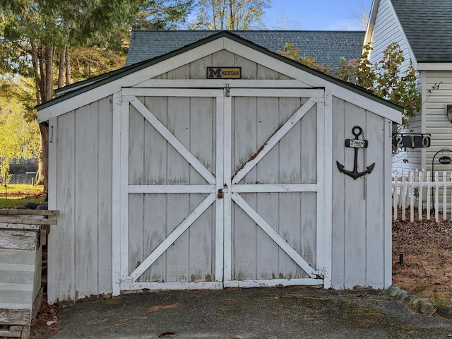 view of shed featuring fence