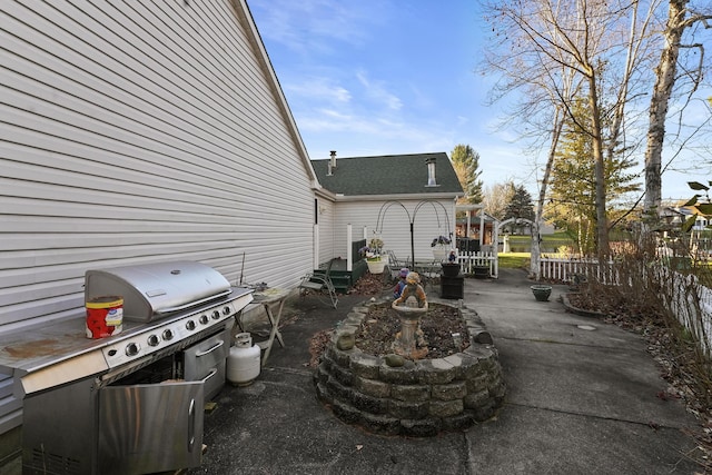 view of patio / terrace with grilling area and fence