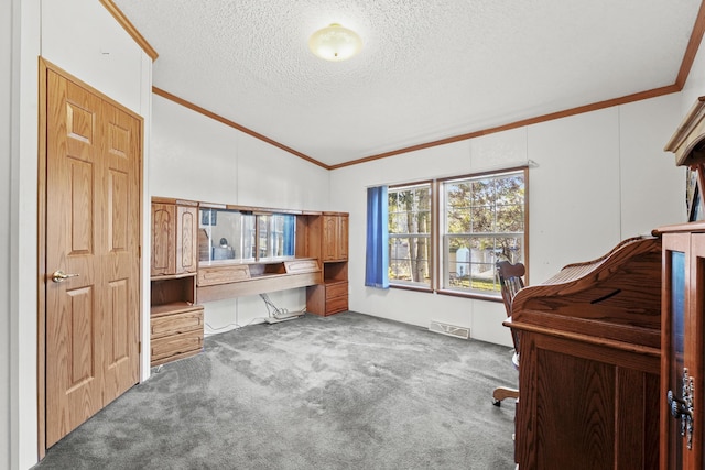 carpeted office featuring visible vents, built in study area, crown molding, lofted ceiling, and a textured ceiling