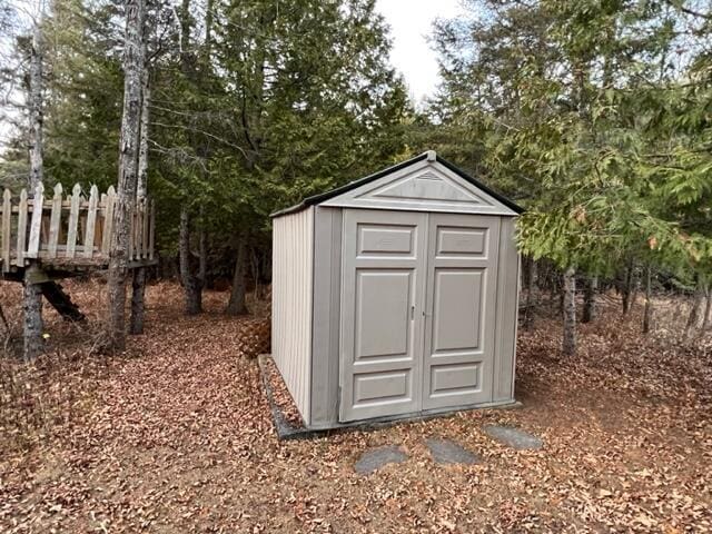 view of shed featuring fence