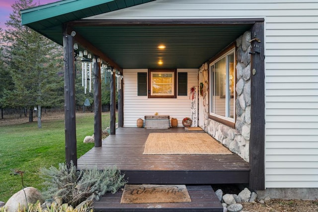 wooden terrace featuring a yard