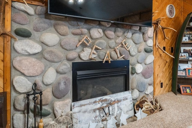 room details featuring a fireplace and carpet floors