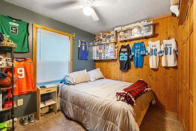 bedroom with wooden walls and carpet