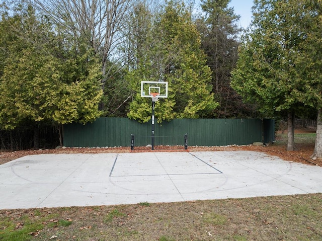 view of sport court featuring basketball court and fence