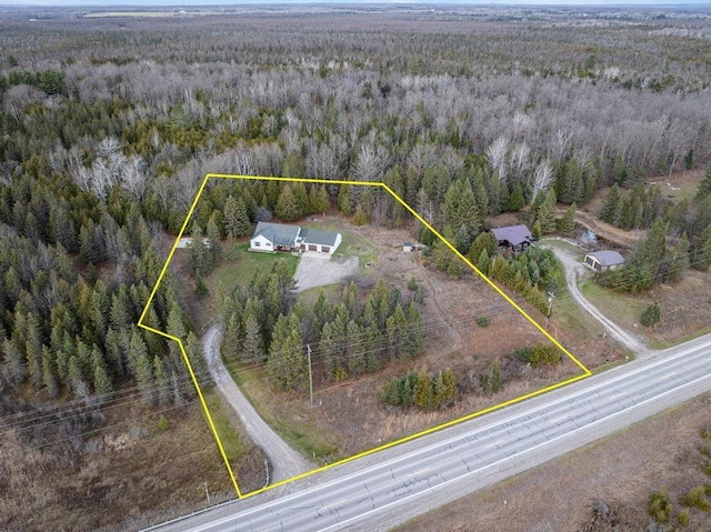 birds eye view of property with a view of trees