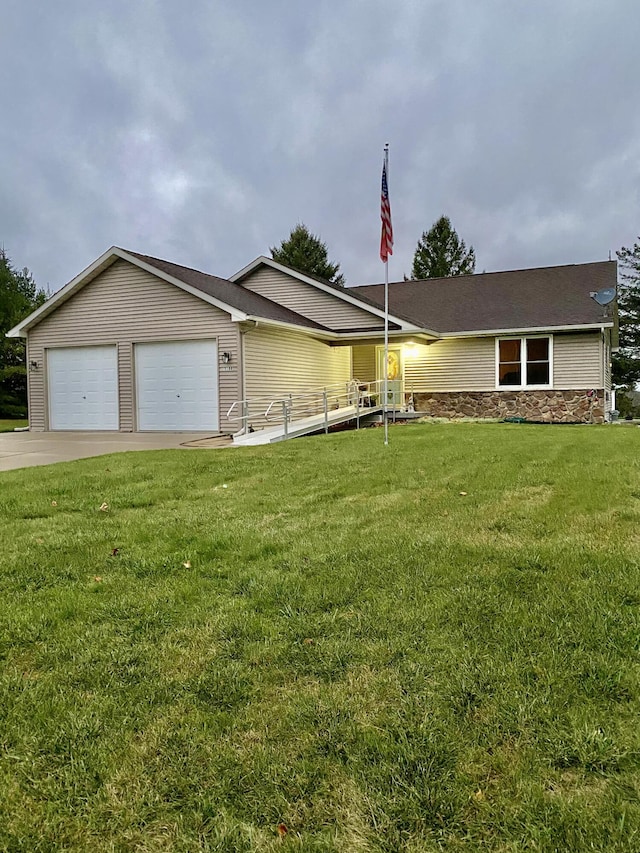 ranch-style home featuring driveway, an attached garage, and a front lawn