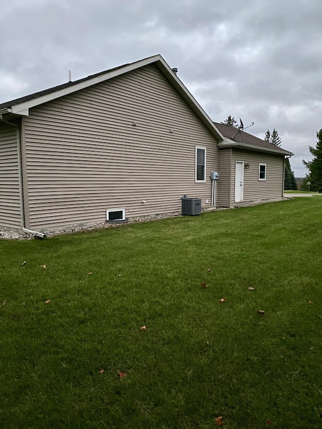 exterior space with a yard and central air condition unit