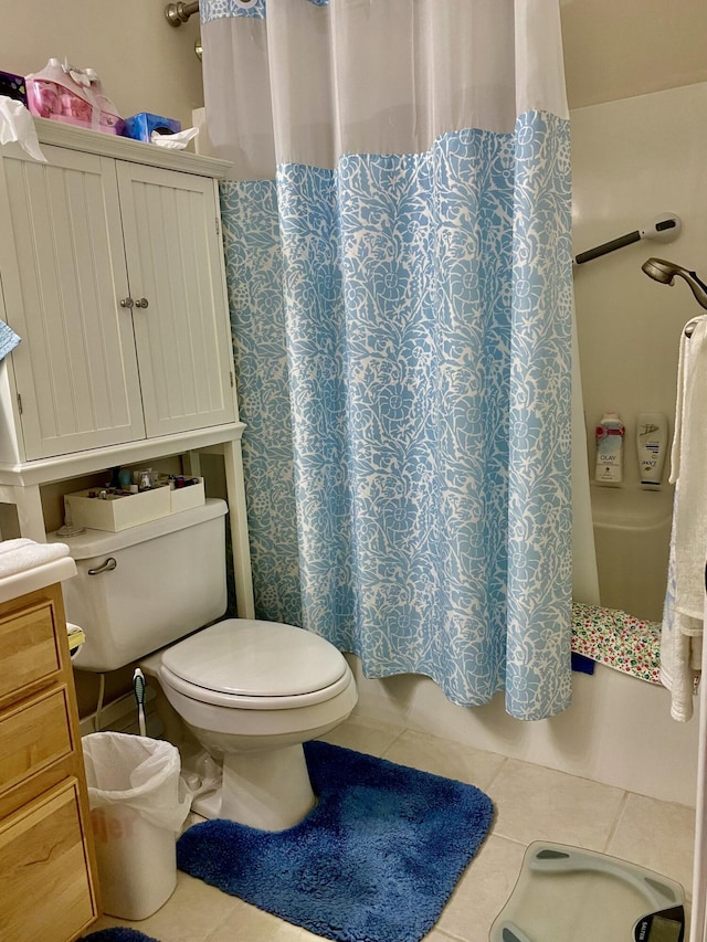 bathroom featuring shower / bathtub combination with curtain, toilet, and tile patterned flooring