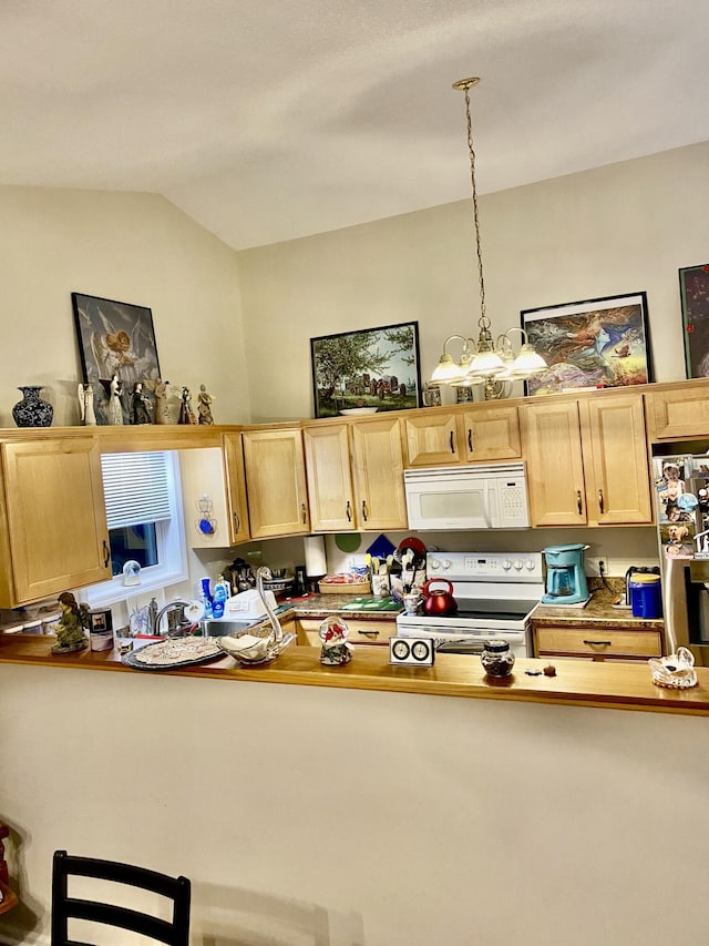 kitchen with decorative light fixtures, white appliances, light brown cabinets, and vaulted ceiling