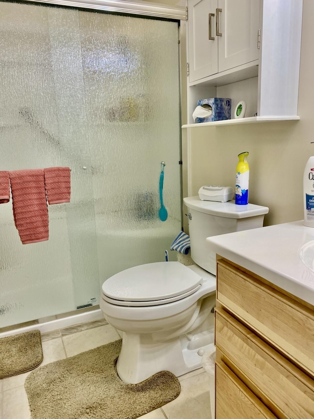 full bath featuring tile patterned floors, vanity, a shower stall, and toilet