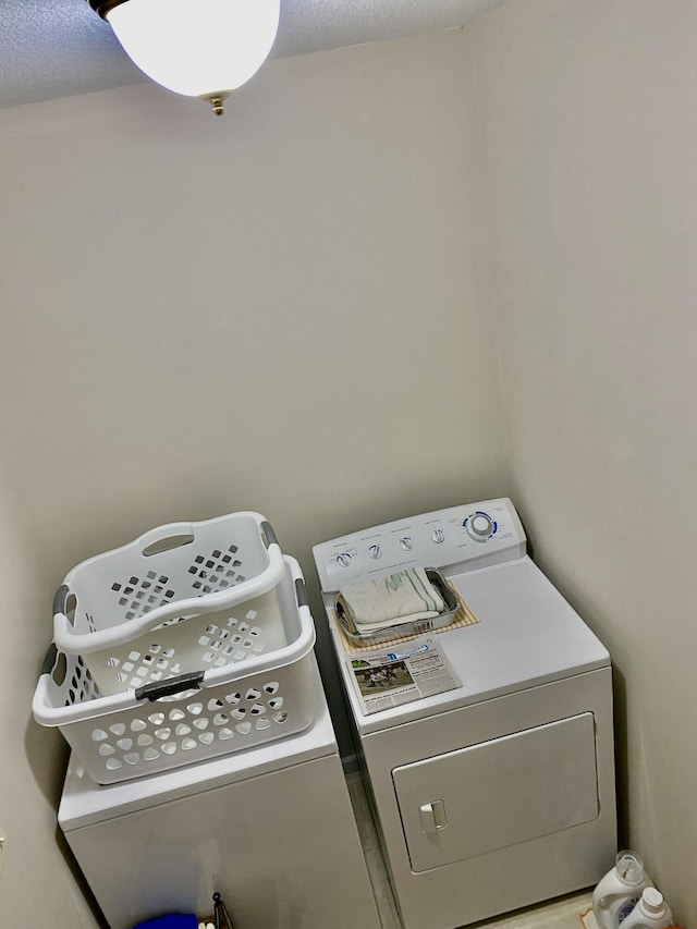 laundry room featuring washing machine and clothes dryer and laundry area