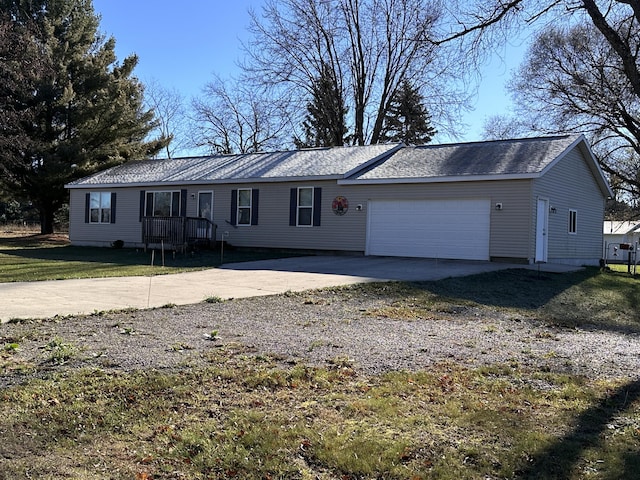 ranch-style house featuring driveway, a front lawn, and a garage