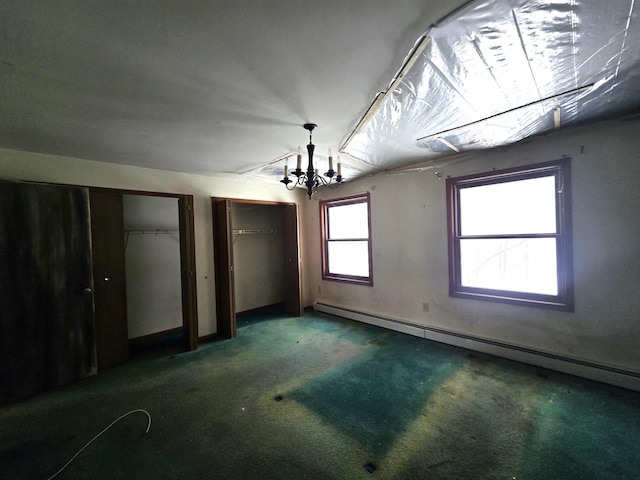 unfurnished bedroom featuring an inviting chandelier, carpet, multiple closets, and baseboard heating