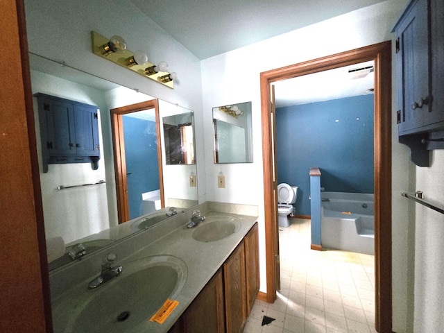 full bathroom featuring toilet, a washtub, and a sink