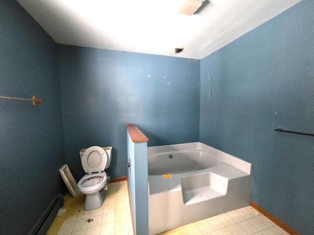 bathroom featuring baseboards, toilet, a garden tub, and a baseboard radiator