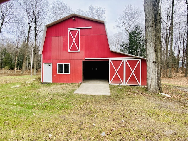 view of barn with a lawn