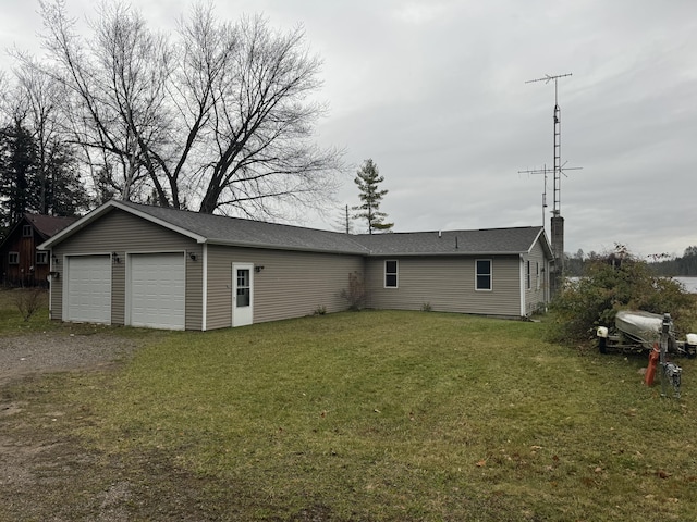 exterior space with a yard and an attached garage