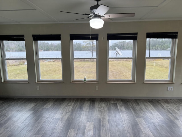 unfurnished sunroom with a water view and a ceiling fan