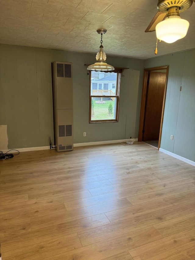 empty room featuring light wood-type flooring and baseboards