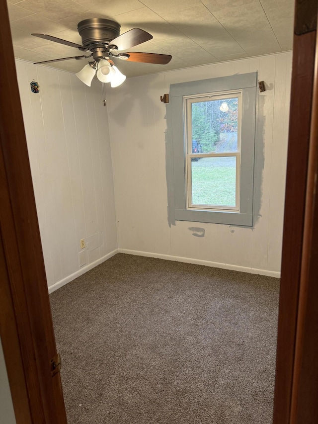 empty room with baseboards, ceiling fan, and carpet floors