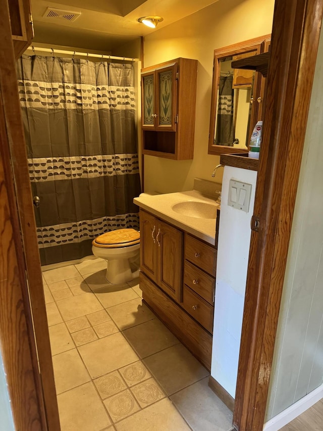 bathroom with tile patterned floors, visible vents, toilet, curtained shower, and vanity