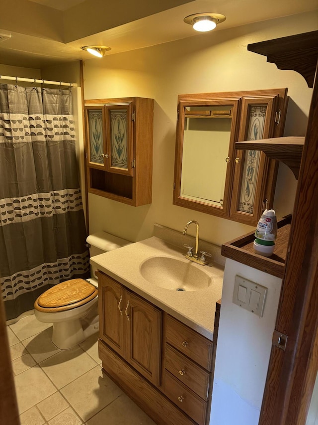 full bathroom with tile patterned flooring, toilet, and vanity