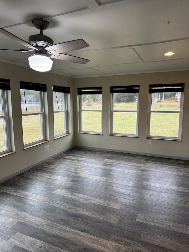 unfurnished sunroom with a ceiling fan