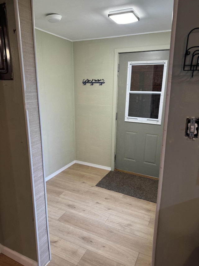 doorway with light wood-style flooring and baseboards