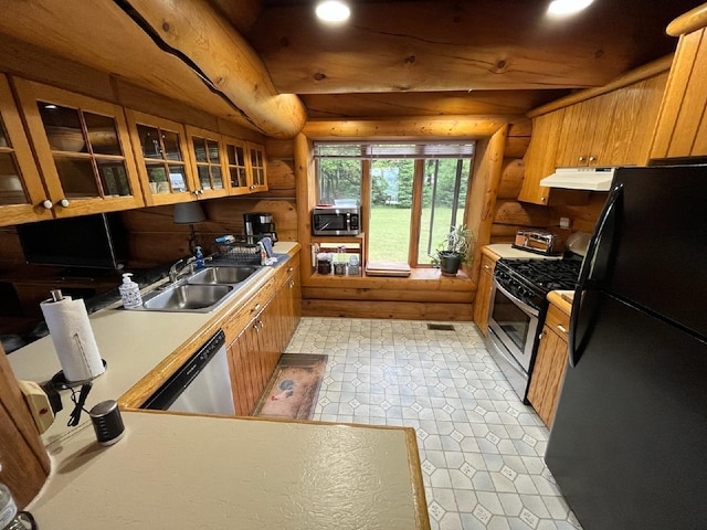 kitchen with under cabinet range hood, brown cabinets, stainless steel appliances, and a sink