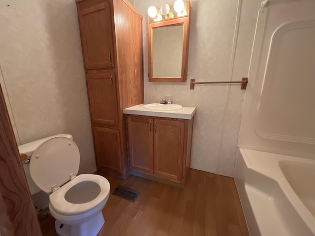 full bathroom with wood finished floors, visible vents, a bathing tub, walk in shower, and toilet