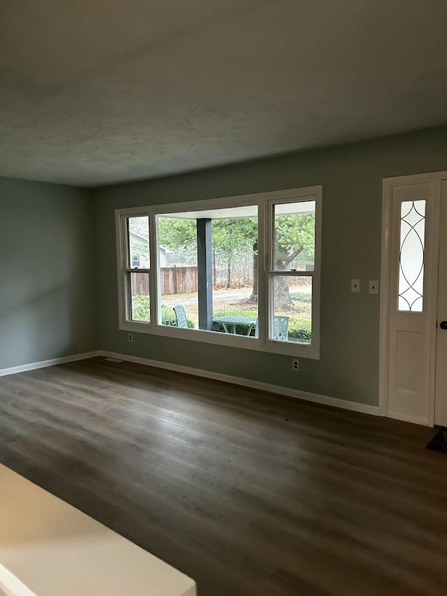 interior space with dark wood-style floors and baseboards