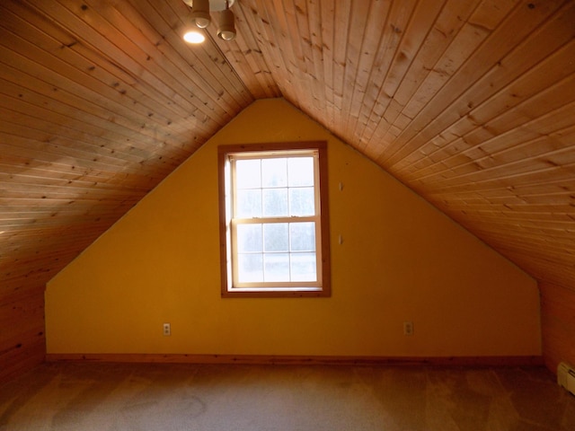 bonus room featuring a baseboard heating unit, lofted ceiling, carpet, and baseboards