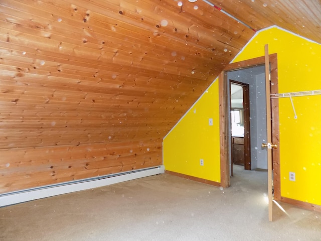 additional living space featuring baseboards, a baseboard heating unit, carpet, and vaulted ceiling