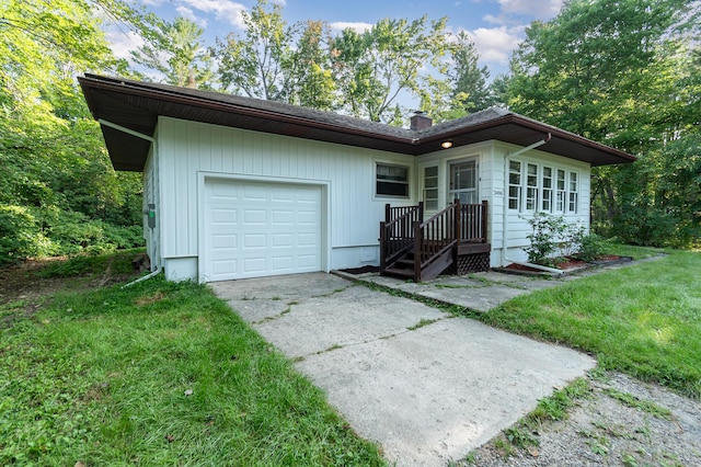 view of front of house with concrete driveway, an attached garage, a front lawn, and a chimney