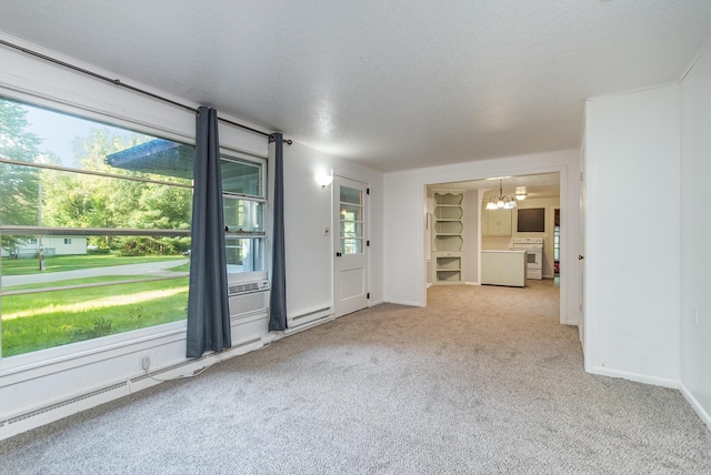 spare room featuring baseboards, a textured ceiling, light colored carpet, baseboard heating, and a chandelier