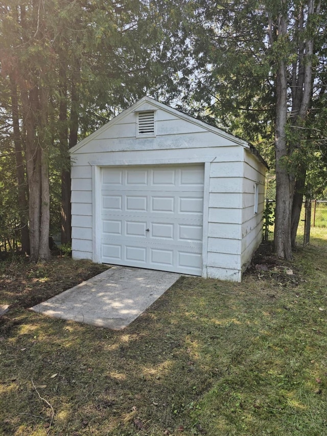 detached garage featuring driveway