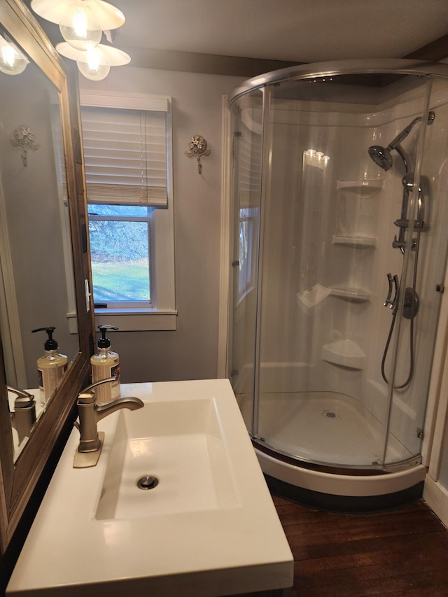 bathroom with a shower stall, vanity, and wood finished floors