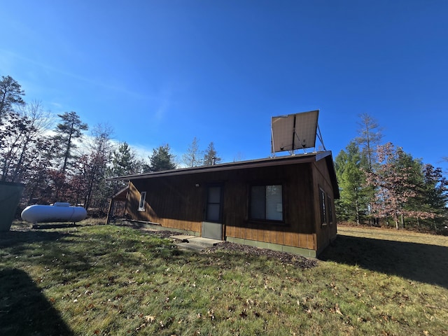 rear view of house featuring a lawn