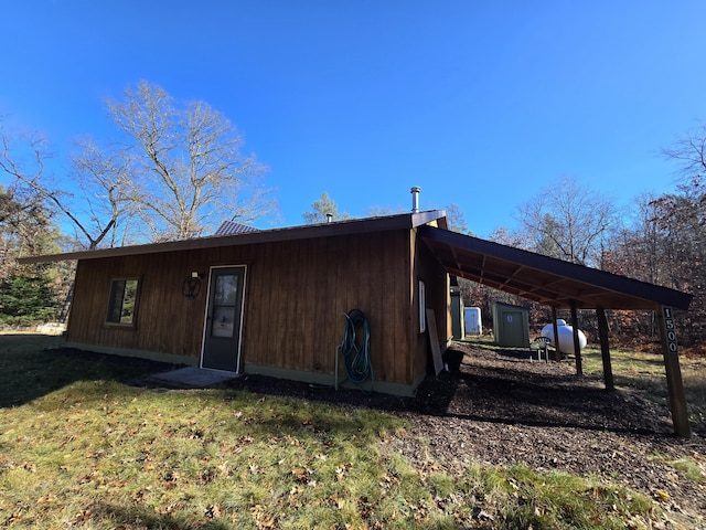 back of property featuring a lawn