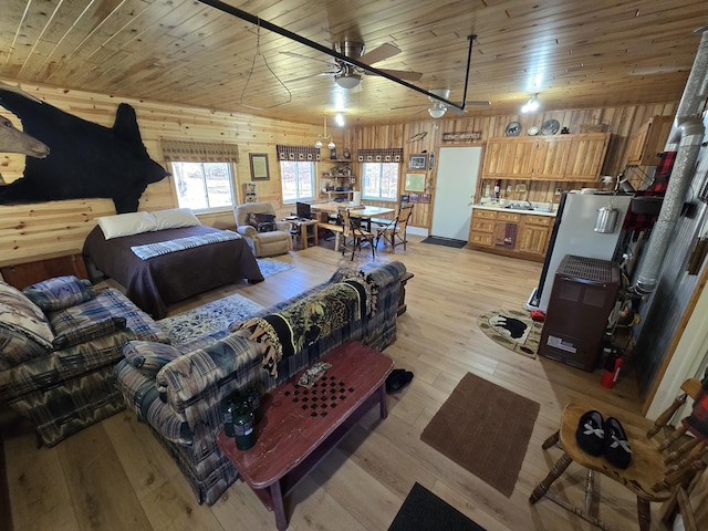 bedroom with wood ceiling, wood walls, and light wood finished floors