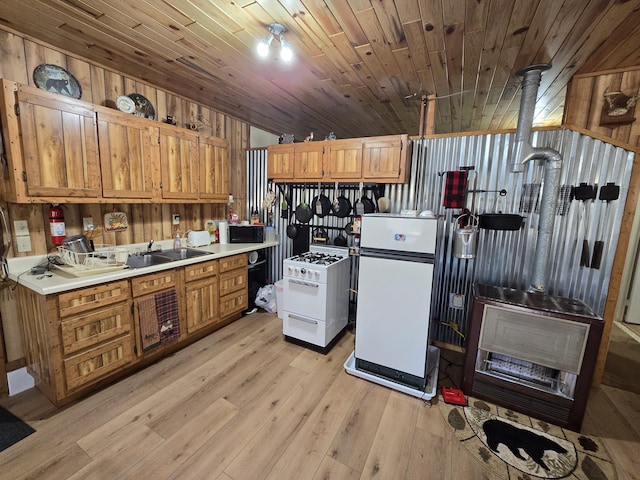 kitchen featuring white appliances, a sink, light countertops, wooden ceiling, and light wood-type flooring