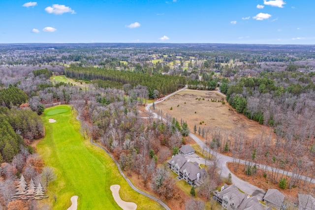 birds eye view of property featuring a wooded view